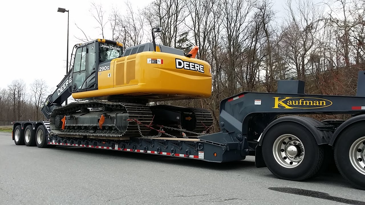 excavator shipping on a lowboy trailer